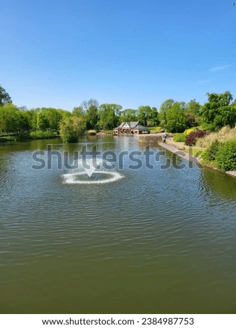 outstanding park picture with beautiful water lake, colourful background, water fountain , blue sky.