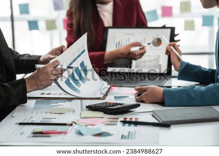 American, African, and Asian employees discuss market research results or sales statistics in briefings with Korean and Caucasian colleagues in the office. Royalty-Free Stock Photo #2384988627