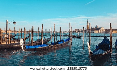 Beautiful seascape with gondolas on the blue sea water in Venice . High quality photo