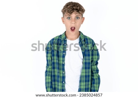 Oh my God. Surprised Happy Caucasian teen boy stares at camera with shocked expression exclaims with unexpectedness, Royalty-Free Stock Photo #2385024857
