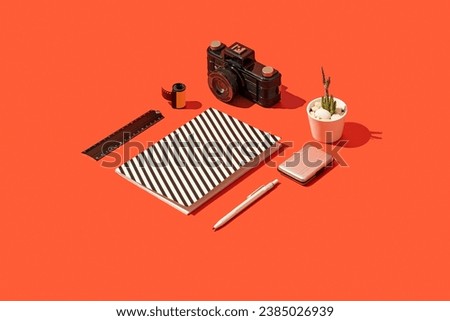 Photography concept flat lay on red background. Notebook; ruler; pencil; cactus; camera and film roll on red background. 