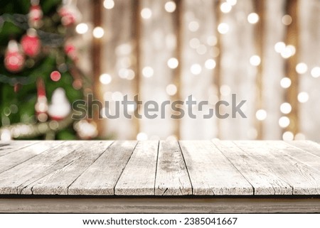 A clean white wooden desk for product presentation with a backdrop of enchanting Christmas tree lights in bokeh. Ideal setup for a captivating and festive product display