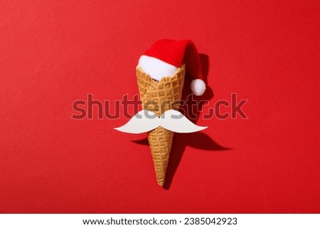 An ice cream cone with a mustache and a Santa hat