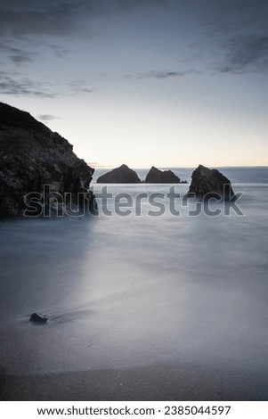 Slow shutter speed photograph of Hollywell bay at sunset.