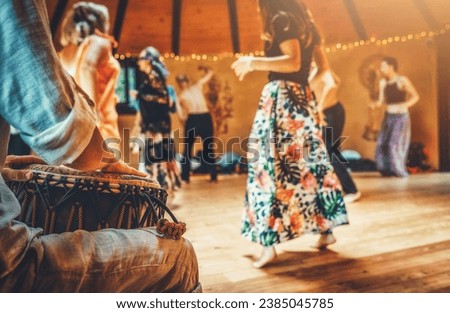 Drummer playing the djembe at the cacao ceremony. Ceremony dance in circle. Ceremony space. Royalty-Free Stock Photo #2385045785