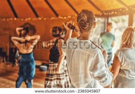 Shaman playing a rain stick at a cacao ceremony. Ceremony dance in circle. Ceremony space. Royalty-Free Stock Photo #2385045807