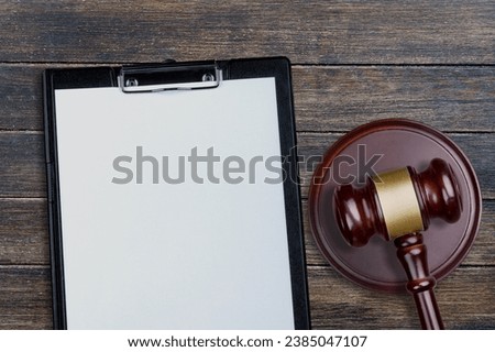 Concept of paperwork with wooden gavel on desk
