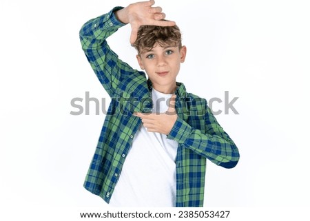 Caucasian teen boy making finger frame with hands. Creativity and photography concept.