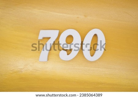 The golden yellow painted wood panel for the background, number 790, is made from white painted wood.