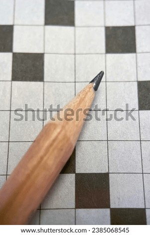 crossword puzzle and pencil on it. close up macro photo.