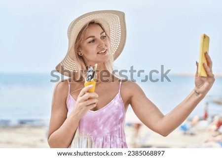 Young blonde woman tourist make selfie by smartphone eating ice cream at seaside