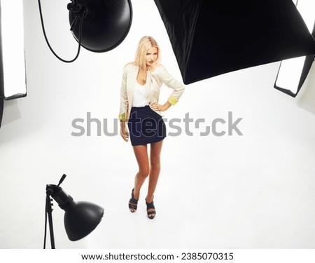 Model, backstage and woman in studio with light, white background and photography of fashion. Photoshoot, lighting and person posing on set, backdrop or production with confident in clothes and style