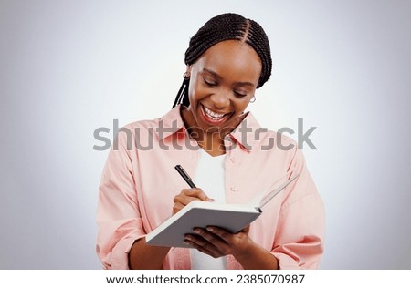 Happy woman, notebook and writing ideas, planning or creative solution for studying, college or education goals in studio. African student with book reminder or notes for learning on white background Royalty-Free Stock Photo #2385070987