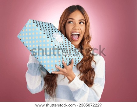 Woman, gift box and studio with thinking, happiness and surprise celebration by gradient background. Student girl, young and happy with present package, excited face and celebrate birthday with smile