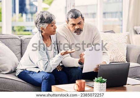 Old couple, laptop and discussion about retirement paperwork, life insurance and finance investment at home. People do taxes online, pension policy documents and budget, woman and man with bills Royalty-Free Stock Photo #2385072257