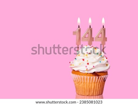 Birthday Cake With Candle Number 144 - On Pink Background.