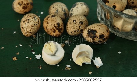 several quail eggs (telur puyuh ) on a green wooden board