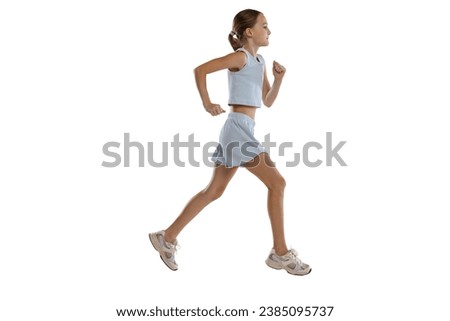 Girl, teenager, athlete training running isolated over white background. Sportive, motivated youth. Concept of action, sport, healthy life, competition, motion, physical activity. Copy space for ad