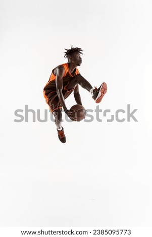 Assist. One young african man, professional basketball player training, practicing isolated over white studio background. Concept of professional sport, healthy lifestyle, motion and action