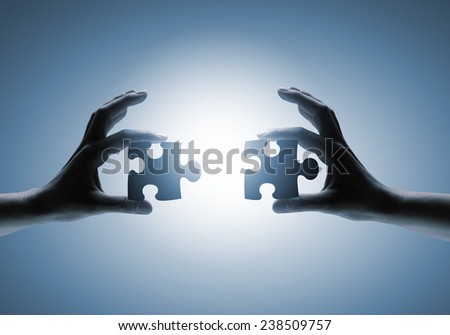 Close up of human hands connecting puzzle elements Royalty-Free Stock Photo #238509757