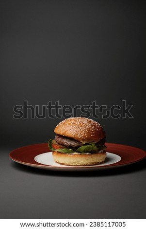 Classic burger on black background with copy space, close-up