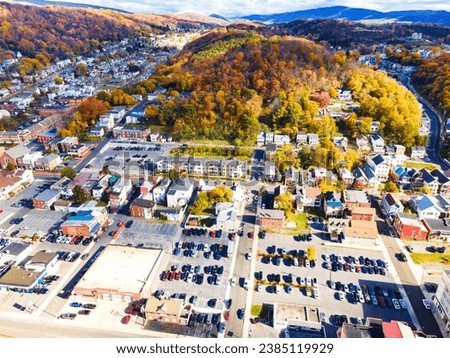 Autumn landscape from above. old town in Maryland in the fall. houses, parking lots with cars, and churches among yellowed trees and hills.