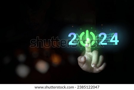 A man's hand is pressing the switch on the 2024 icon. that shows technology concepts to move towards the new year 2024 and presented the concept of opening a business in 2024 Royalty-Free Stock Photo #2385122047