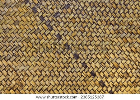 solid background wicker straw flat wall. the texture of a woven straw product such as a tray or hat. background or banner for use as a graphic resource on a website or wallpaper. tied straw crisscross