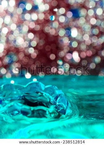 Abstract, colorful composition with small bokeh lights and water texture. Can be used as Christmas background 