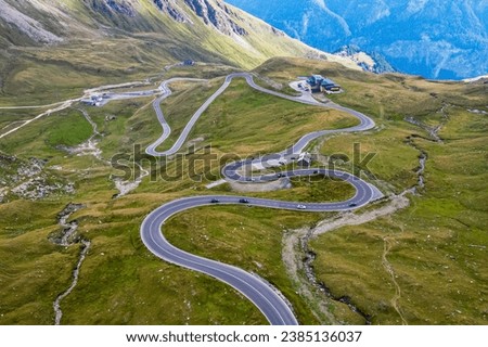 Beautiful view of the famous Austrian seršentine road Grossglockner Hochalpenstrasse. Aerial view of scenic Grossglockner High Alpine Road route in Austria with mountains and clouds in summer Royalty-Free Stock Photo #2385136037