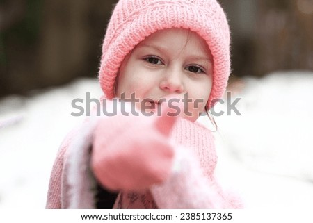 little girl in a hat in winter concept cold season holidays