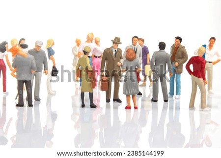 miniature people. group of different people communicate with each other on a white background. concept of communications and relations in society. Royalty-Free Stock Photo #2385144199