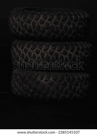 Three tires of a miniature off-road car
