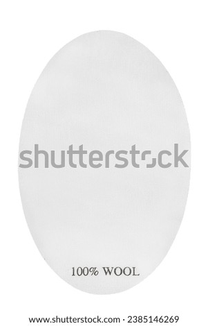 Clothes label says 100% wool isolated on white background