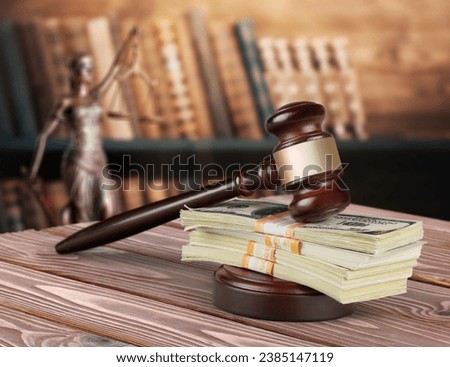 Wooden desk in courtroom, money and material concept Royalty-Free Stock Photo #2385147119