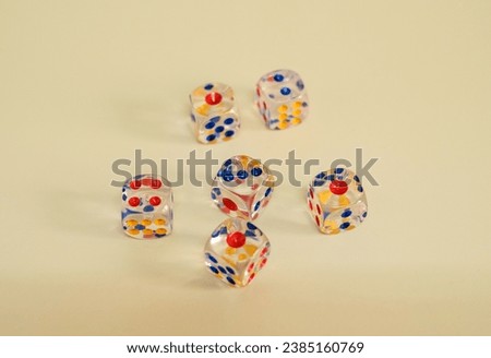 A group of coloured dice  on yellow surface