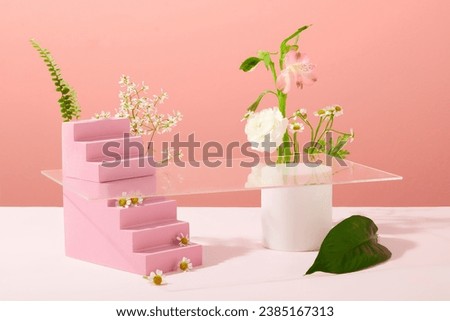 Front view of a ladder-shaped pink painted wooden podium is decorated with daisies and props on a pastel background. Space for product display and advertising.