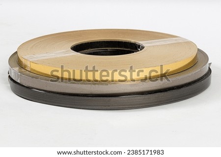 Baking paper on wooden board isolated. Round board with crumpled pieces of brown parchment or baking paper on white background.
