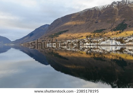 small town mirrors in the sea with a streak of sun Royalty-Free Stock Photo #2385178195