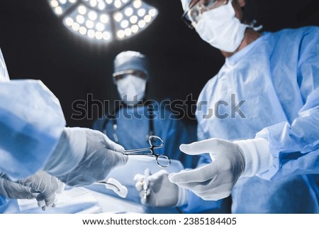 Close up of surgery team operating in modern hospital. Medical workers teamwork, saving rescuing patient`s life during plastic cardio surgery. Organs transplantation Royalty-Free Stock Photo #2385184405