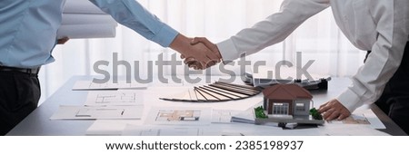 Interior designer shake hand with client or colleagues after made successful sketching and choosing mood board materials or color selection for modern house interior design. Insight