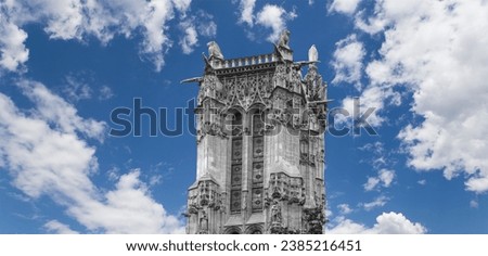 Saint-Jacques Tower (Tour Saint-Jacques) against the background of a beautiful sky with clouds. Located on Rivoli street, Paris, France. This 52 m Flamboyant Gothic tower (XVI century)    