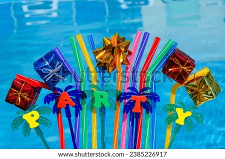 The inscription Party on a blue pool background. Festive decoration of palm tree and gifts on a background of blue water.