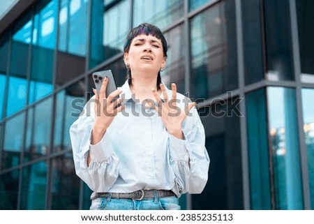 Portrait of a young woman talking in anger on her mobile to her boyfriend about ending their relationship Royalty-Free Stock Photo #2385235113