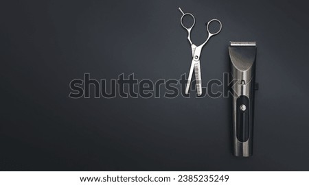 Barbershop concept. Hair clipper and Hairdresser scissors on black background top view space for text. Hair extensions, materials and cosmetics, hair care, wig. Hairstyle, haircut in salon Royalty-Free Stock Photo #2385235249