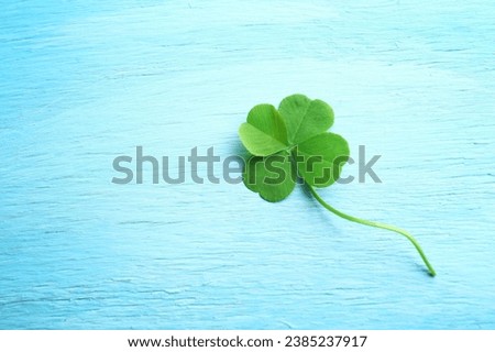 A four leaf clover under a starry night sky, symbolizing luck and dreams. Perfect for dreamy and magical themed designs. Royalty-Free Stock Photo #2385237917