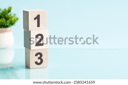 number 1, 2, 3 - text on wooden blocks on wooden background. business concept Royalty-Free Stock Photo #2385241659