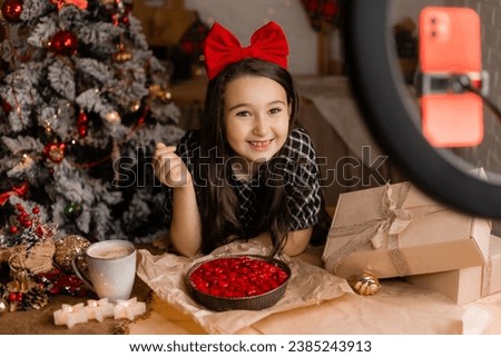 little girl blogger leads the broadcast and cooks a pie at home for Christmas. High quality photo