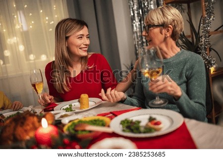 Mother and daughter having great time at Christmas dinner