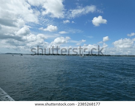 A monohull  sailboat cruising on the auckland harbour by devonport. november 2023. Royalty-Free Stock Photo #2385268177